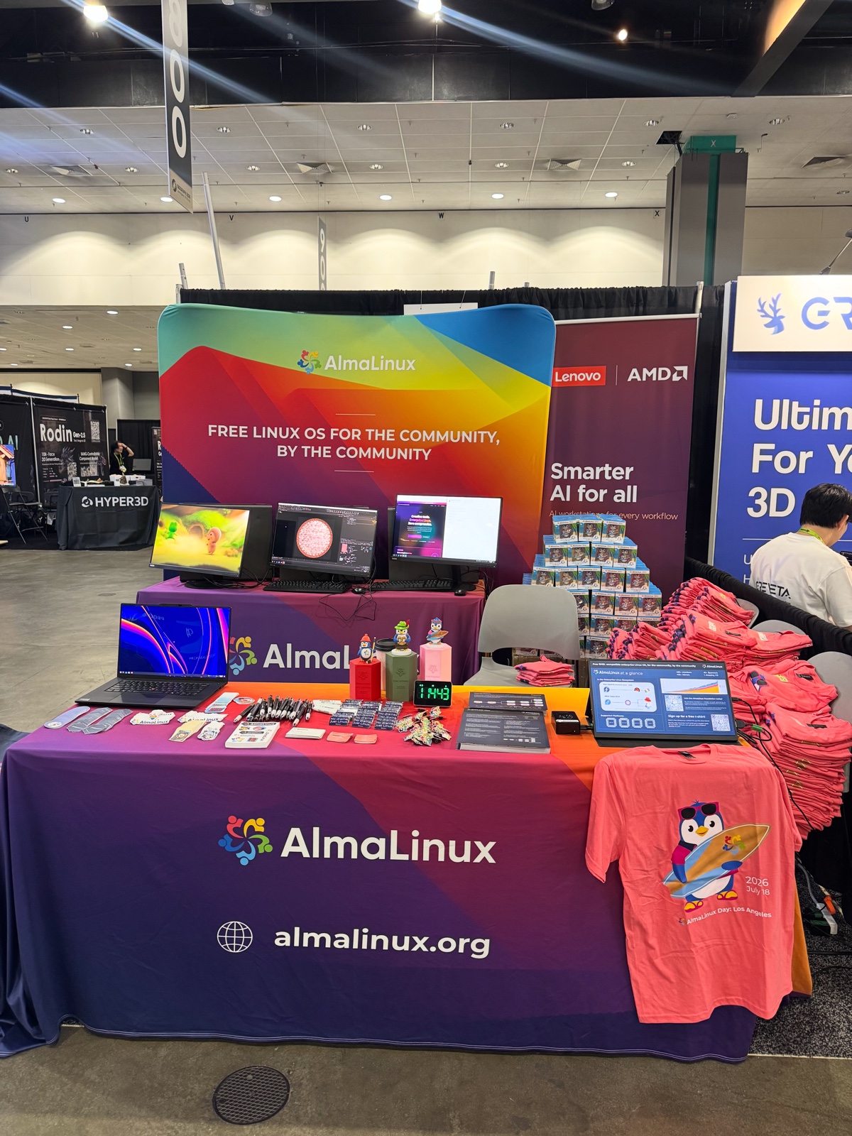 The AlmaLinux booth at SIGGRAPH 2026, showing Lenovo and AMD hardware running AlmaLinux